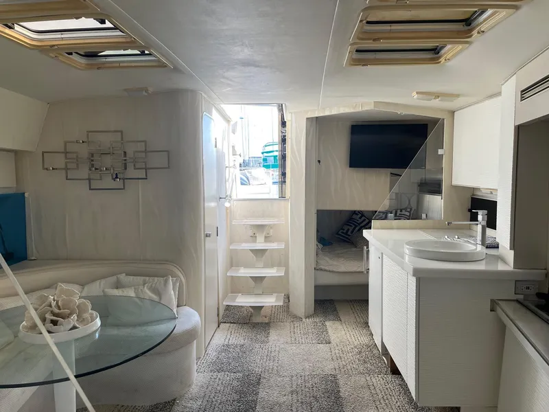 Slide: The Image of Interior of a 1993 Silverton 38 Express yacht, featuring modern decor and a cozy living space. - 4