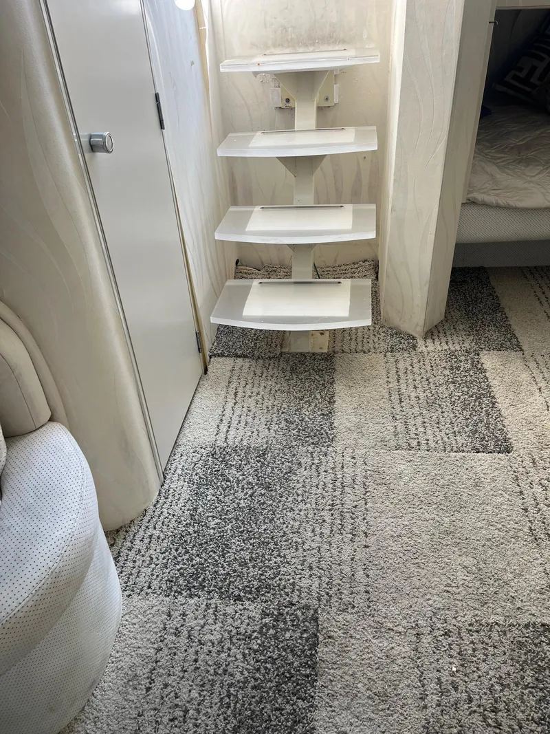 Slide: The Image of Interior of 1993 Silverton 38 Express yacht with carpeted floor and modern steps. - 9