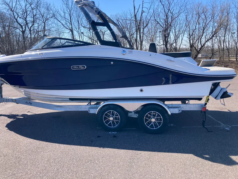 Slide: The Image of 2025 Sea Ray SPX 210 boat on trailer, parked outdoors. - 3