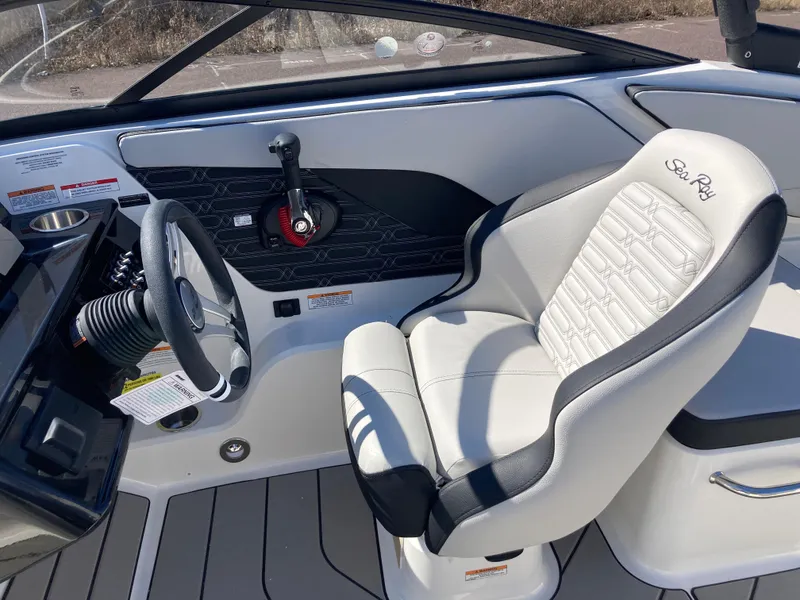 Slide: The Image of 2025 Sea Ray SPX 210 boat interior with steering wheel and captain's seat. - 7
