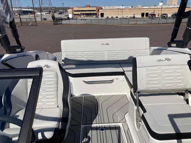 Slide: The Image of 2025 Sea Ray SPX 210 boat interior with white seating and modern design. - 8