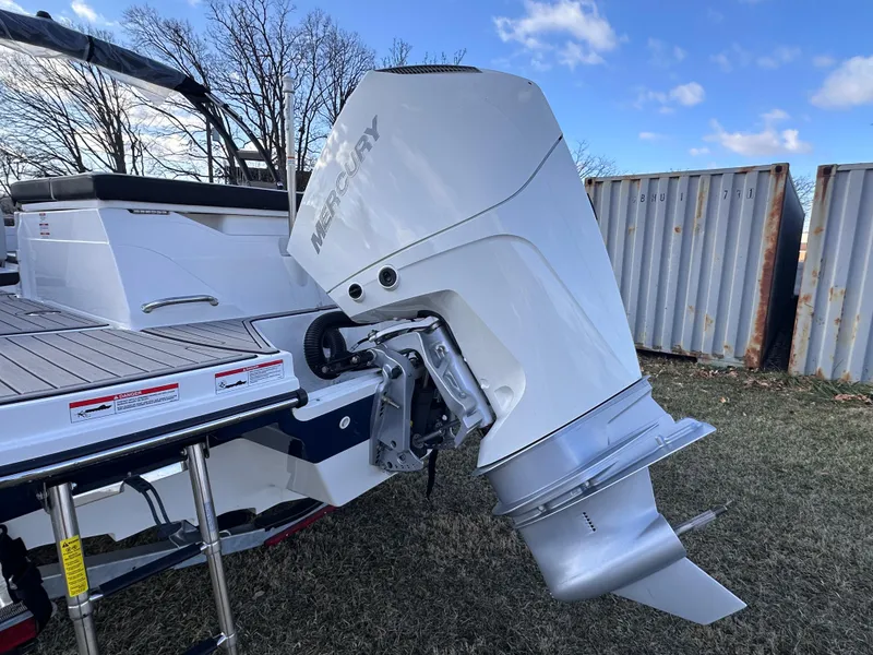 Slide: The Image of 2025 Sea Ray SPX 230 OB boat with Mercury outboard engine, parked on grass. - 10