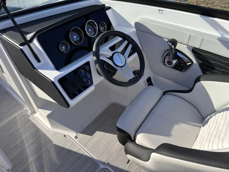 Slide: The Image of 2025 Sea Ray SPX 230 OB boat cockpit with modern steering and controls. - 2