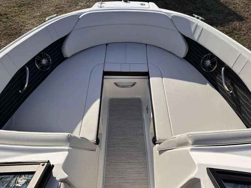 Slide: The Image of 2025 Sea Ray SPX 230 OB boat interior with cushioned seating and sleek design. - 7