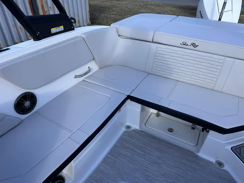 Slide: The Image of 2025 Sea Ray SPX 230 OB boat interior with white seating and storage compartments. - 8