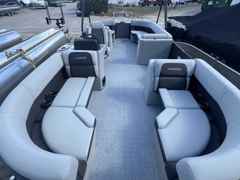 Slide: The Image of 2024 Harris Cruiser 210 pontoon boat with spacious seating and modern design. - 5