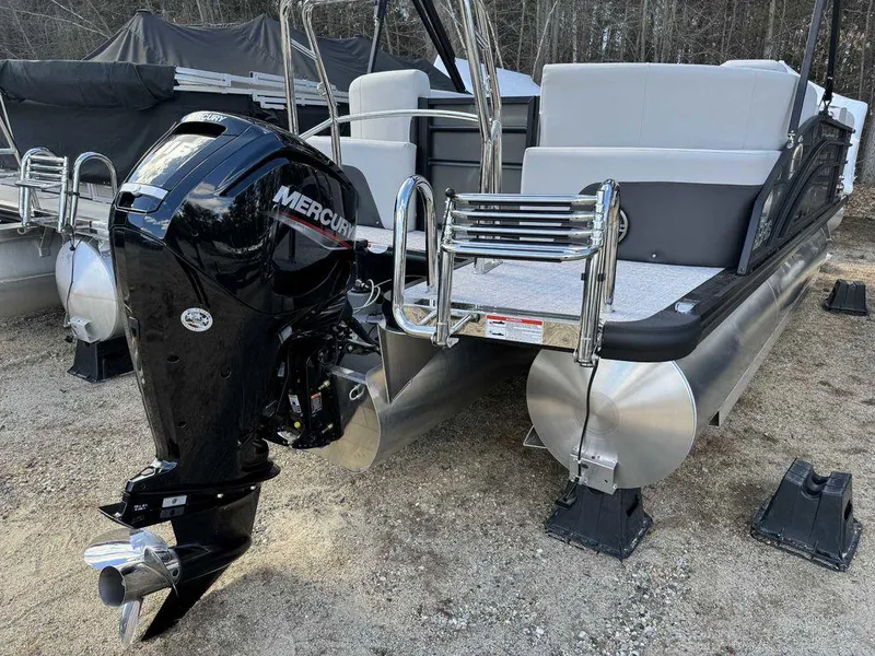 Slide: The Image of 2024 Harris Cruiser 210 pontoon boat with Mercury outboard motor, rear view. - 6