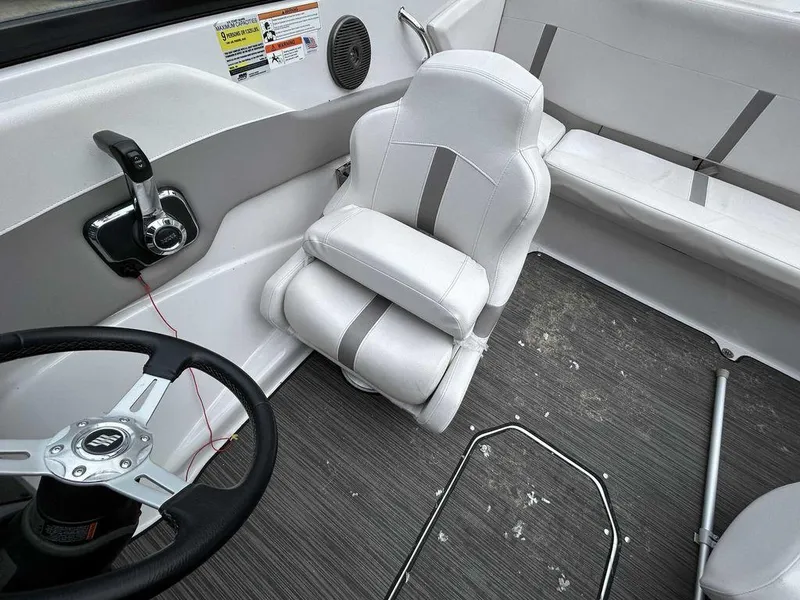 Slide: The Image of 2018 Four Winns Horizon 190 boat interior with white seating and steering wheel. - 11