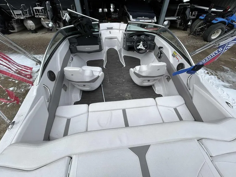 Slide: The Image of 2018 Four Winns Horizon 190 boat interior with white seating and modern dashboard. - 14