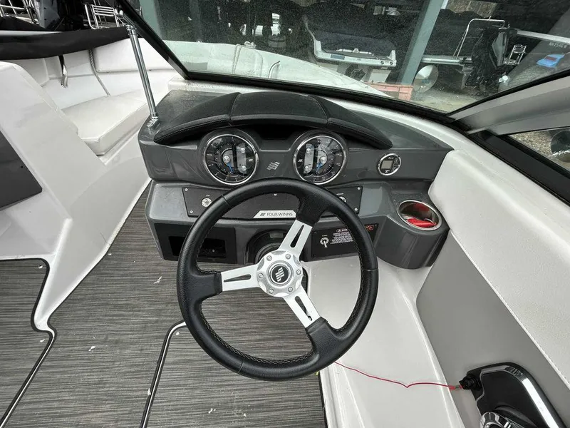 Slide: The Image of 2018 Four Winns Horizon 190 dashboard with steering wheel and gauges. - 9