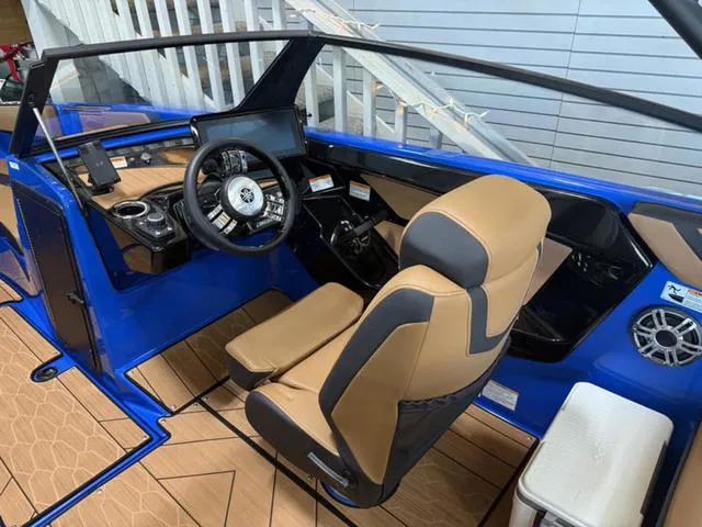 Slide: The Image of 2025 Yamaha Boats 222XD cockpit with modern steering, blue accents, and tan seating. - 10