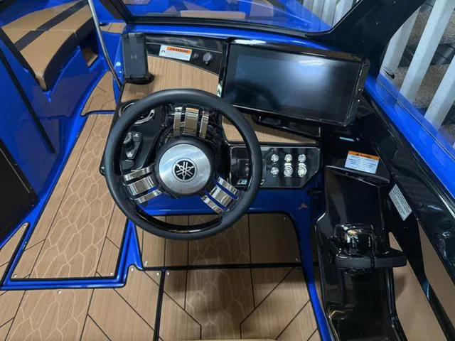 Slide: The Image of 2025 Yamaha Boats 222XD cockpit with steering wheel and control panel, featuring modern design. - 12