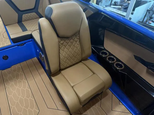 Slide: The Image of 2025 Yamaha Boats 222XD interior with tan leather seating and blue accents. - 21