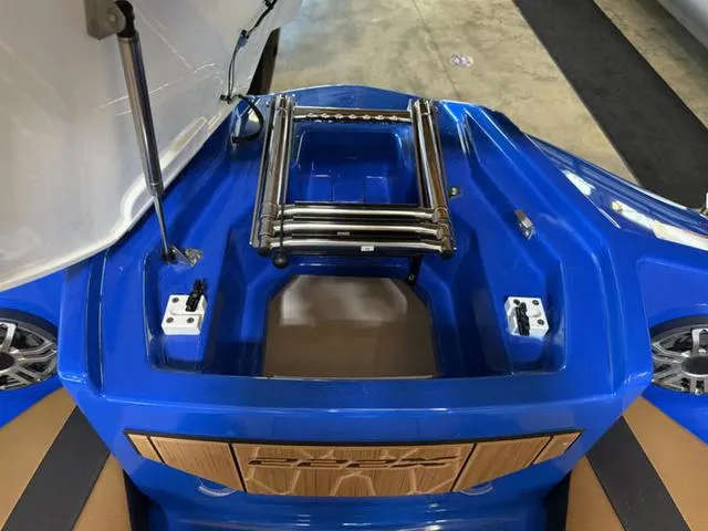 Slide: The Image of 2025 Yamaha Boats 222XD, blue deck with foldable ladder and storage compartment. - 27