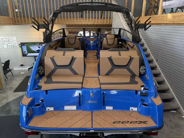 Slide: The Image of 2025 Yamaha Boats 222XD, blue exterior, luxurious seating, showcased indoors. - 3