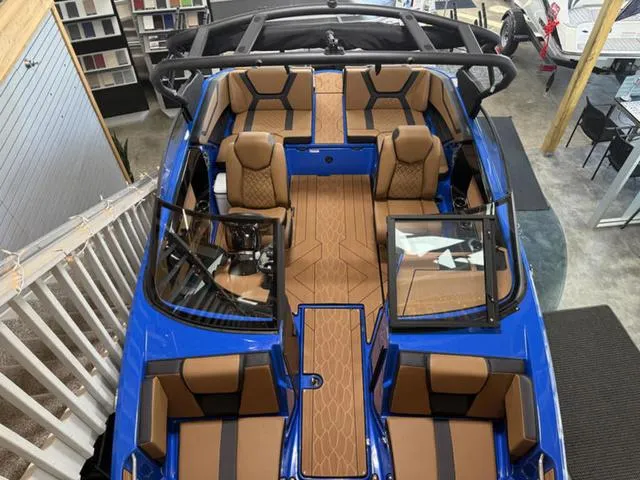 Slide: The Image of 2025 Yamaha Boats 222XD interior, featuring luxurious brown seating and sleek blue exterior. - 5