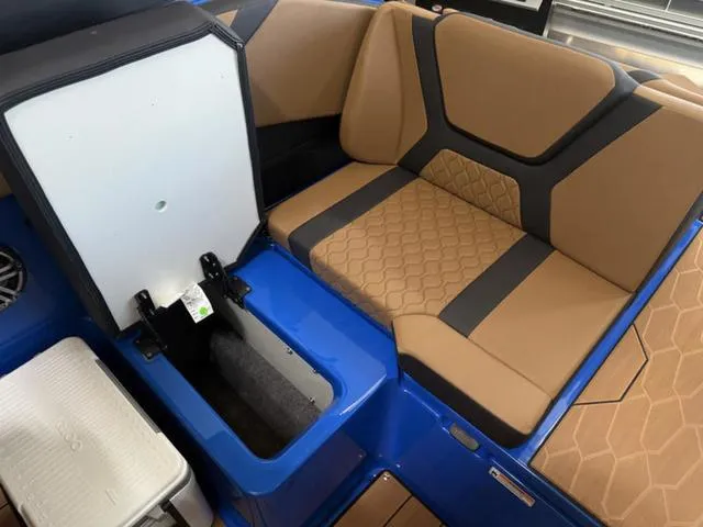 Slide: The Image of 2025 Yamaha Boats 222XD interior with tan seating and storage compartment. - 8