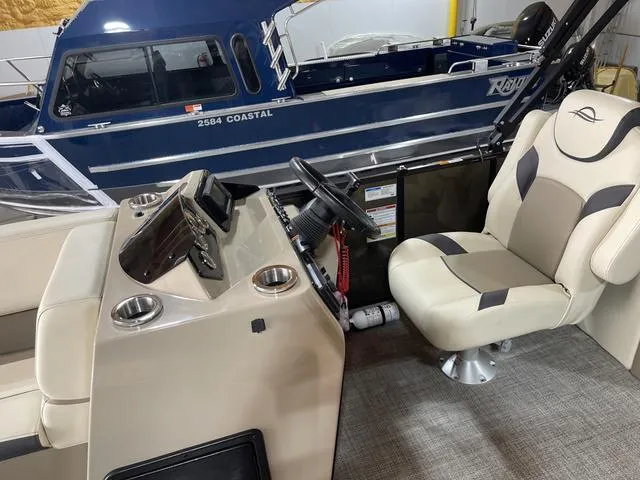 Slide: The Image of 2025 SunCatcher Select 322SS boat interior with steering console and comfortable seating. - 12