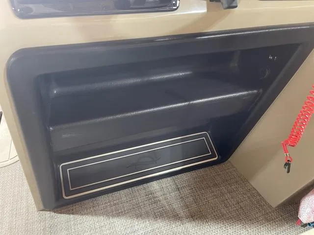 Slide: The Image of Storage compartment in a 2025 SunCatcher Select 322SS boat interior. - 14