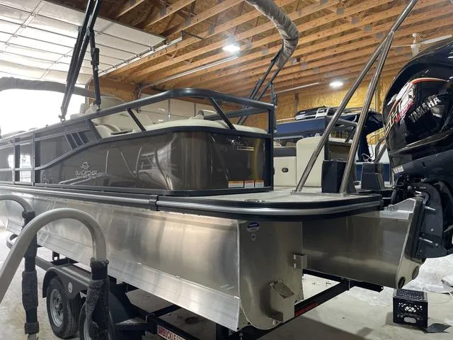 Slide: The Image of 2025 SunCatcher Select 322SS pontoon boat in a garage, featuring Yamaha outboard motor. - 4