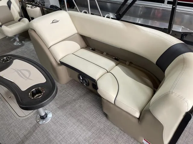 Slide: The Image of 2025 SunCatcher Select 322SS boat interior with beige seating and table. - 9