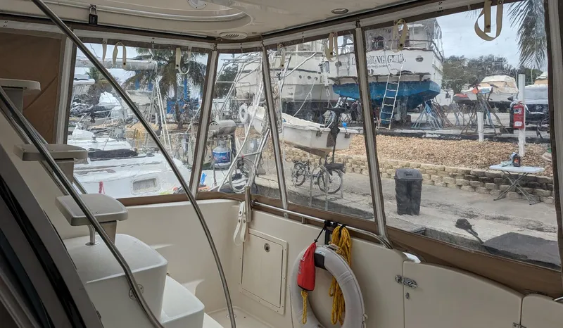 Slide: The Image of Interior view of 1999 Maxum 4100 SCB yacht with marina background. - 10