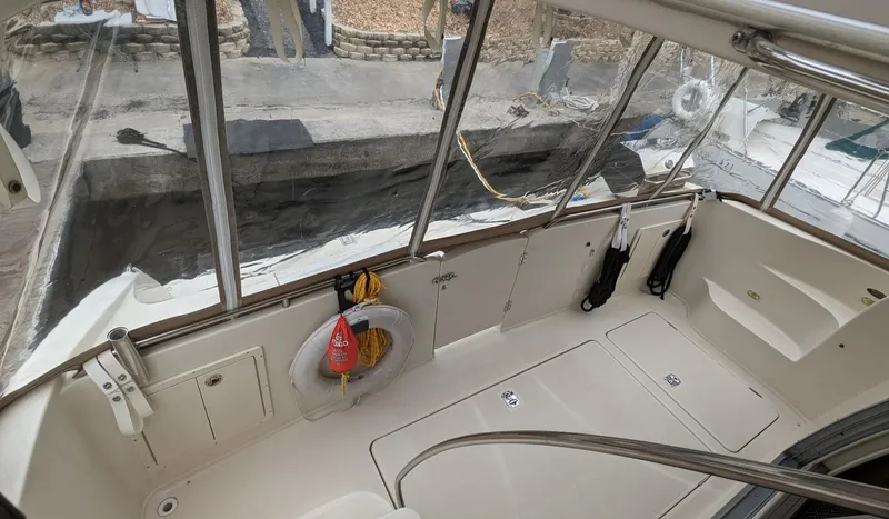 Slide: The Image of 1999 Maxum 4100 SCB boat interior with life preserver and dock view. - 11