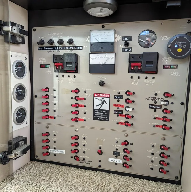 Slide: The Image of Electrical control panel of a 1999 Maxum 4100 SCB boat, featuring switches and gauges. - 15