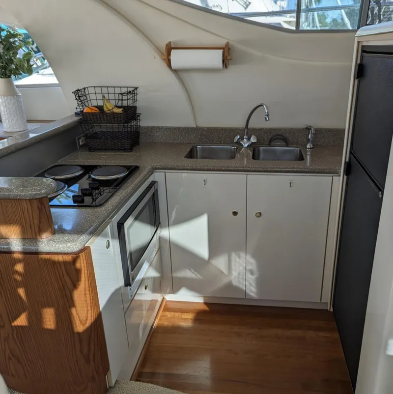 Slide: The Image of 1999 Maxum 4100 SCB yacht kitchen with modern appliances and sleek design. - 17