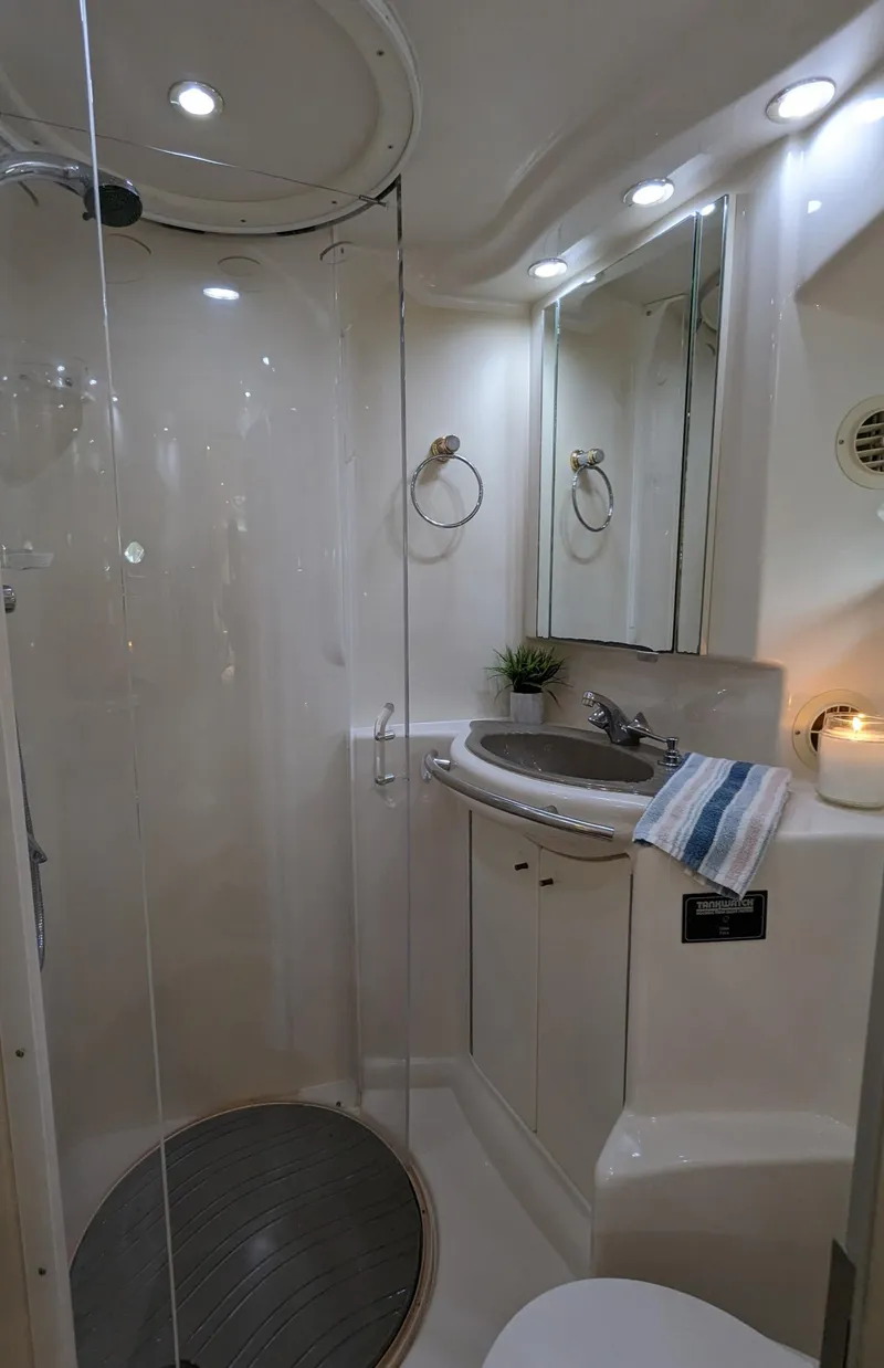 Slide: The Image of 1999 Maxum 4100 SCB yacht bathroom with modern fixtures and glass shower. - 21