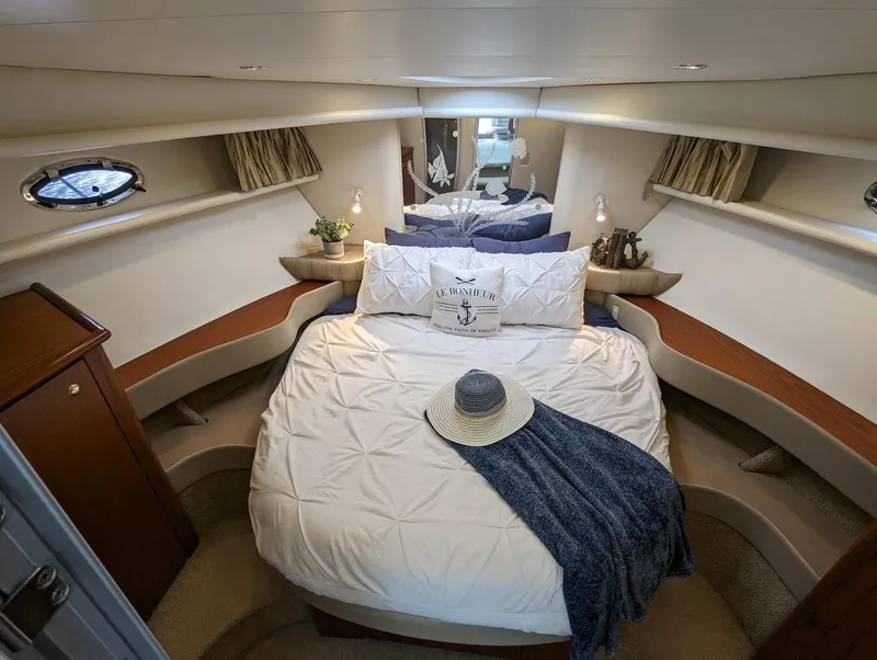 Slide: The Image of Luxurious cabin interior of 1999 Maxum 4100 SCB yacht with elegant bedding and decor. - 22