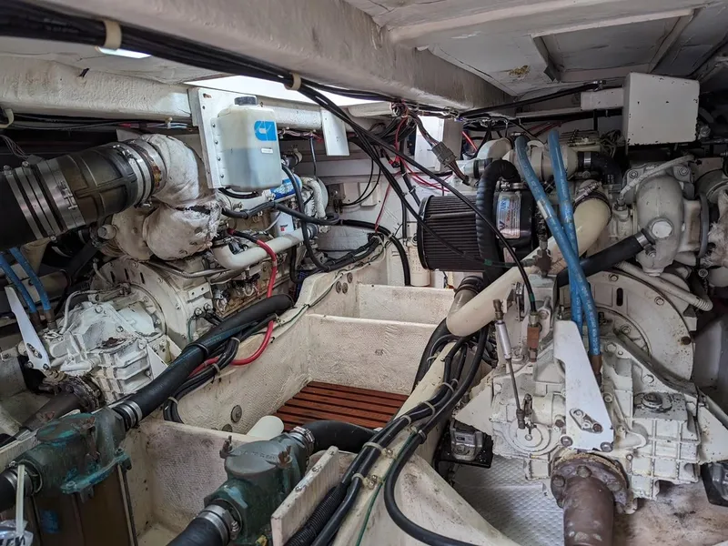 Slide: The Image of Engine room of a 1999 Maxum 4100 SCB yacht, showcasing mechanical components and wiring. - 25