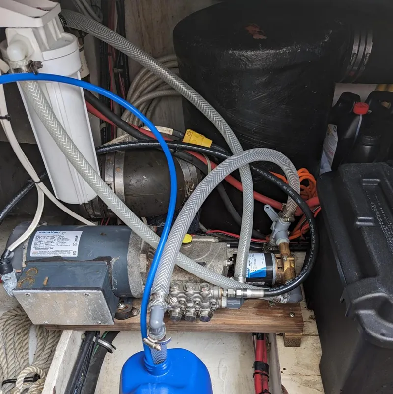 Slide: The Image of Engine compartment of a 1999 Maxum 4100 SCB boat with visible hoses and components. - 26