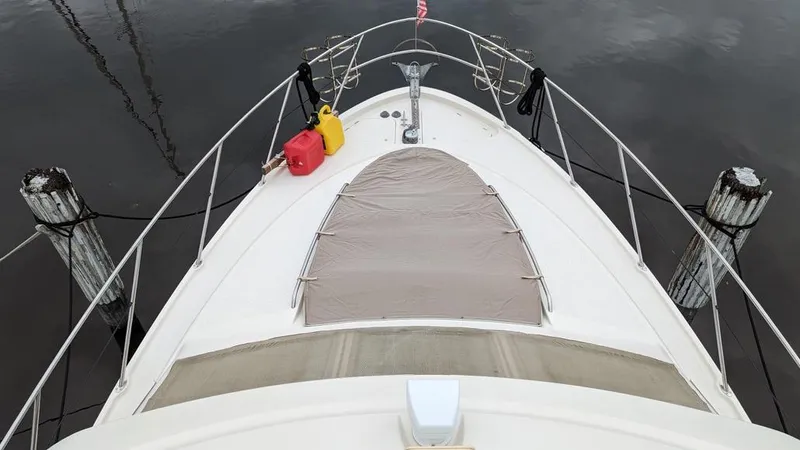 Slide: The Image of 1999 Maxum 4100 SCB yacht bow view with fuel containers on deck. - 4