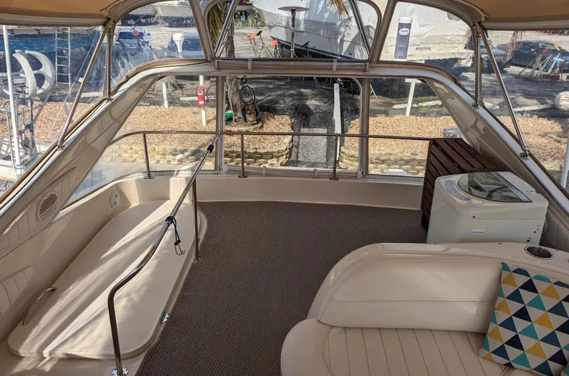 Slide: The Image of 1999 Maxum 4100 SCB yacht interior with beige seating and patterned cushion. - 8