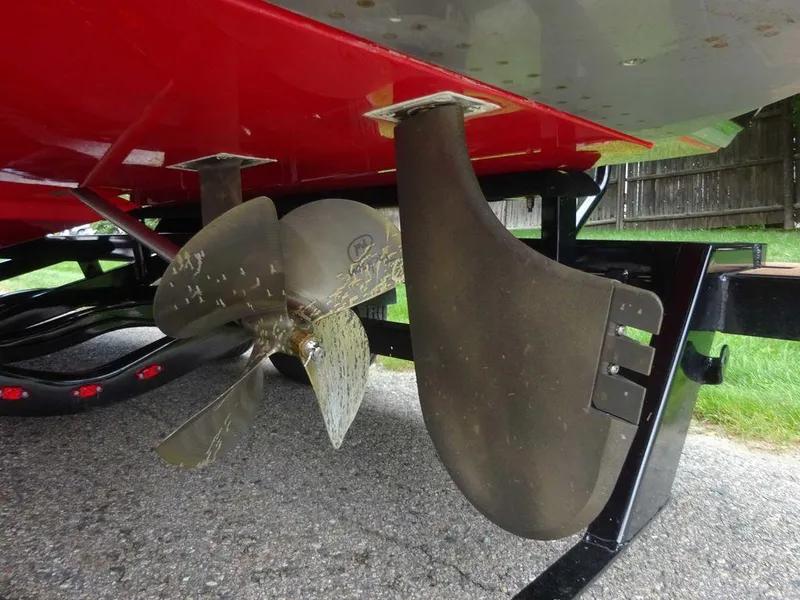 Slide: The Image of 2021 Nautique G23 boat propeller and rudder detail, parked on a trailer. - 17