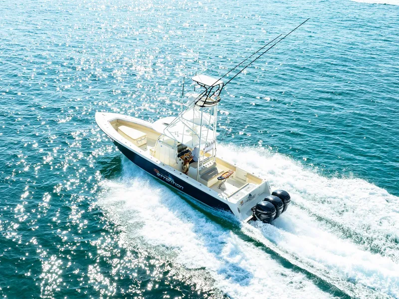 Slide: The Image of 2012 Contender 39 ST boat cruising on sparkling blue water. - 2