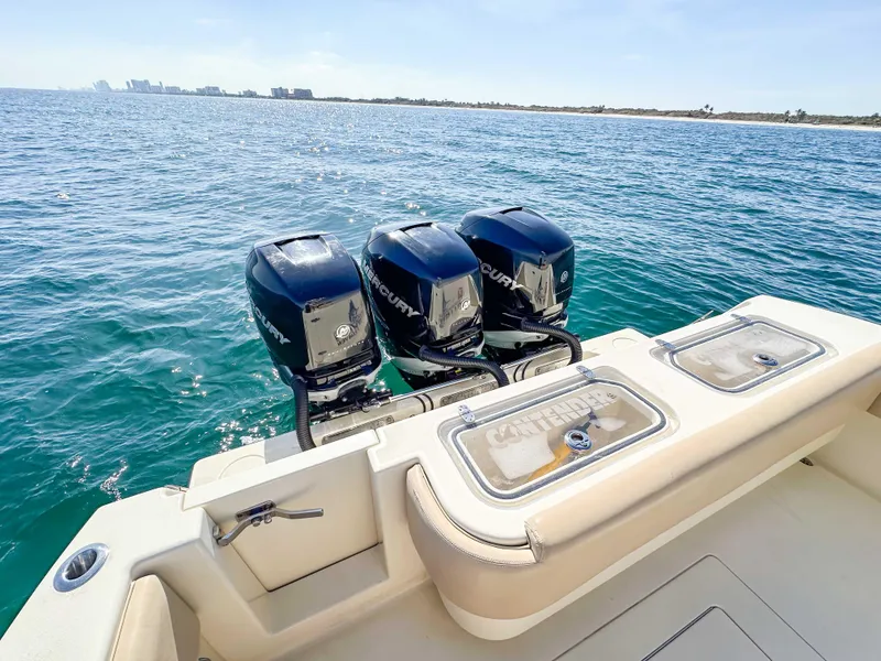 Slide: The Image of 2012 Contender 39 ST boat with triple outboard engines on open water. - 27