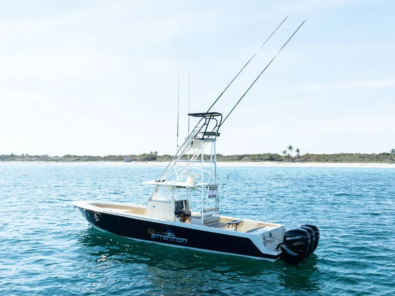 Slide: The Image of 2012 Contender 39 ST boat on calm ocean near shoreline. - 9