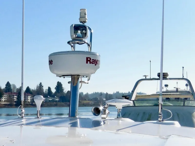 Slide: The Image of 2017 Jeanneau Leader 46 yacht with radar equipment on deck, set against a serene waterfront backdrop. - 19