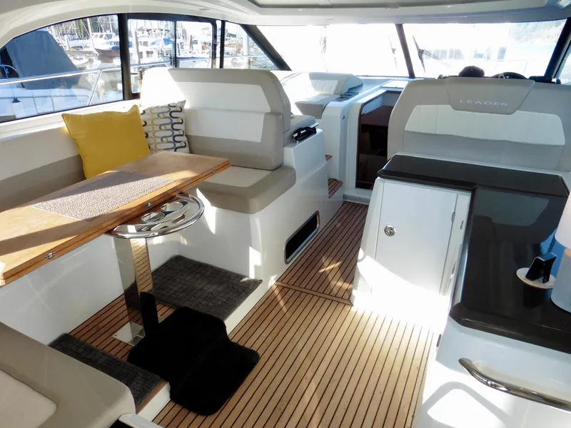 Slide: The Image of 2017 Jeanneau Leader 46 yacht interior with seating, table, and helm station. - 27