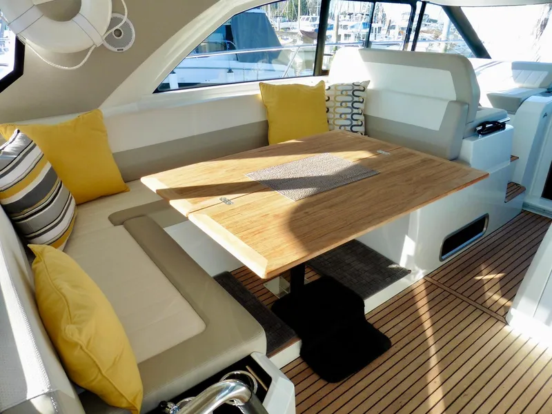 Slide: The Image of Interior of 2017 Jeanneau Leader 46 yacht with cozy seating and wooden table. - 28