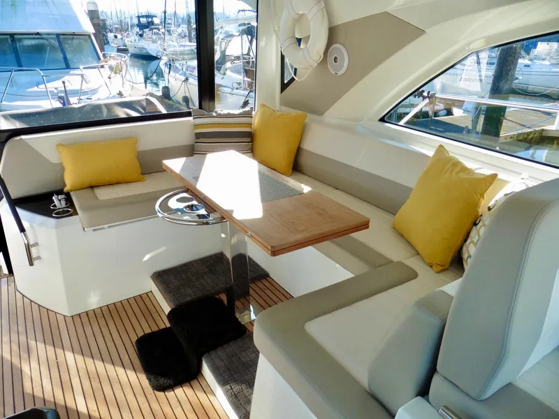 Slide: The Image of 2017 Jeanneau Leader 46 yacht interior with cushioned seating and wooden table. - 30