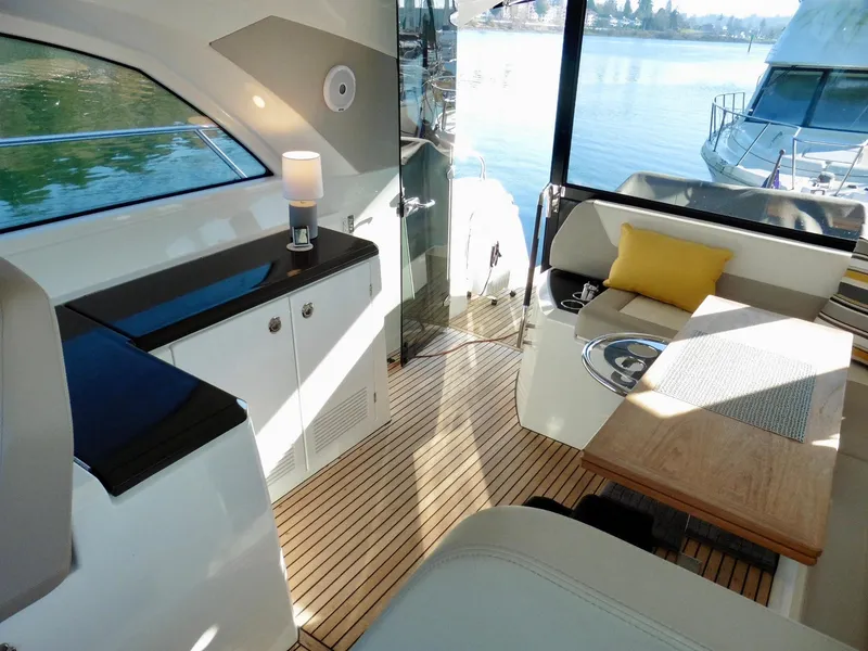 Slide: The Image of Interior of 2017 Jeanneau Leader 46 yacht with elegant seating and waterfront view. - 32