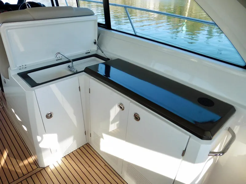 Slide: The Image of 2017 Jeanneau Leader 46 yacht interior with sleek kitchenette and wooden flooring. - 33