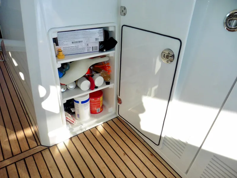 Slide: The Image of Storage compartment on 2017 Jeanneau Leader 46 yacht with various items on wooden deck. - 34