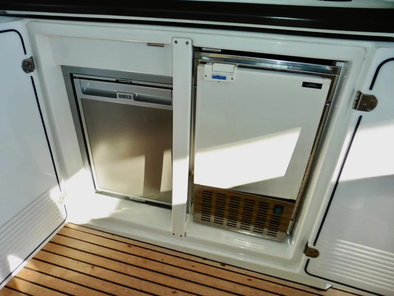 Slide: The Image of 2017 Jeanneau Leader 46 yacht interior with built-in refrigerator and freezer on teak flooring. - 35