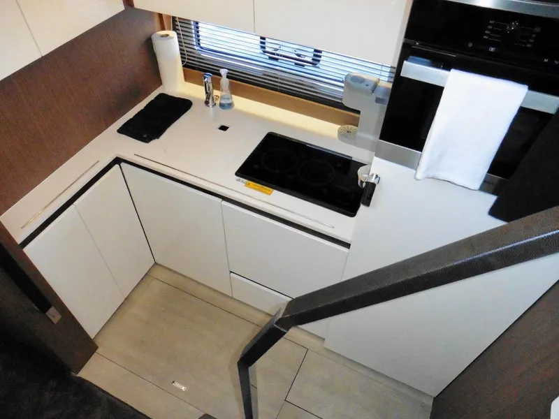 Slide: The Image of Modern kitchen interior of 2017 Jeanneau Leader 46 yacht, featuring sleek countertops and appliances. - 42