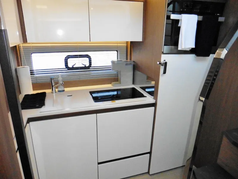 Slide: The Image of Modern kitchen interior of 2017 Jeanneau Leader 46 yacht, featuring sleek cabinetry and appliances. - 44