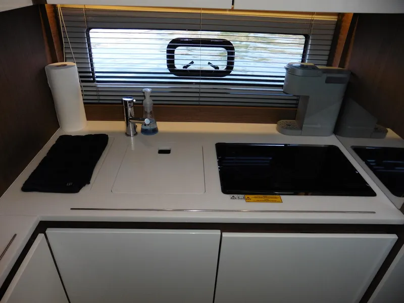 Slide: The Image of Modern kitchen area in a 2017 Jeanneau Leader 46 yacht with sleek appliances. - 49